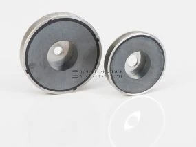 Magnetic system with cylindrical through-hole, stainless steel housing and magnetic core made of ferrite